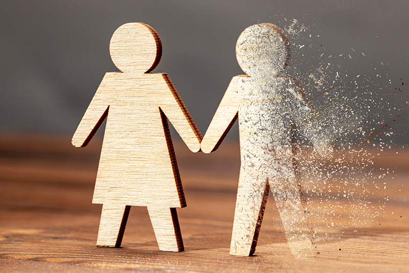 Wooden human shaped figures with the concept is dead husband - blowing ashes from deceased spouse.