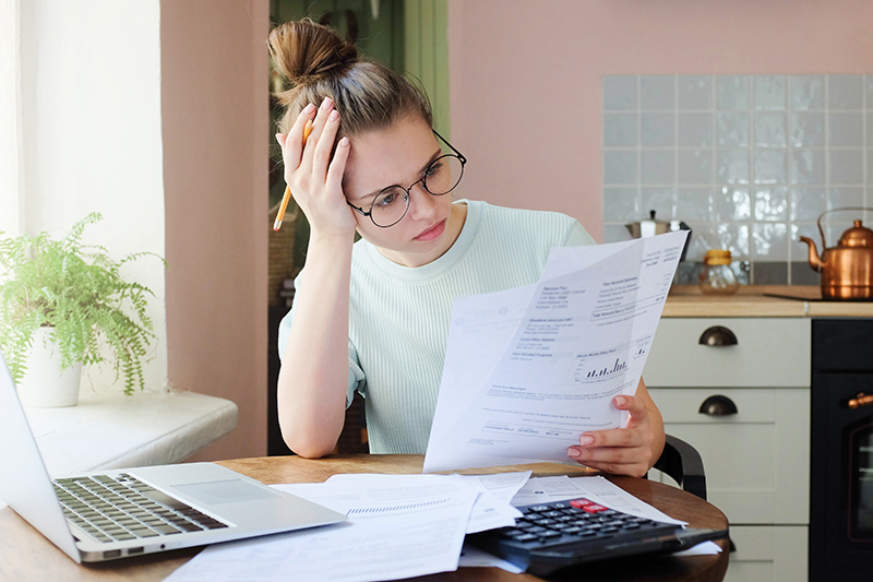 Concerned Woman Reading Paperwork