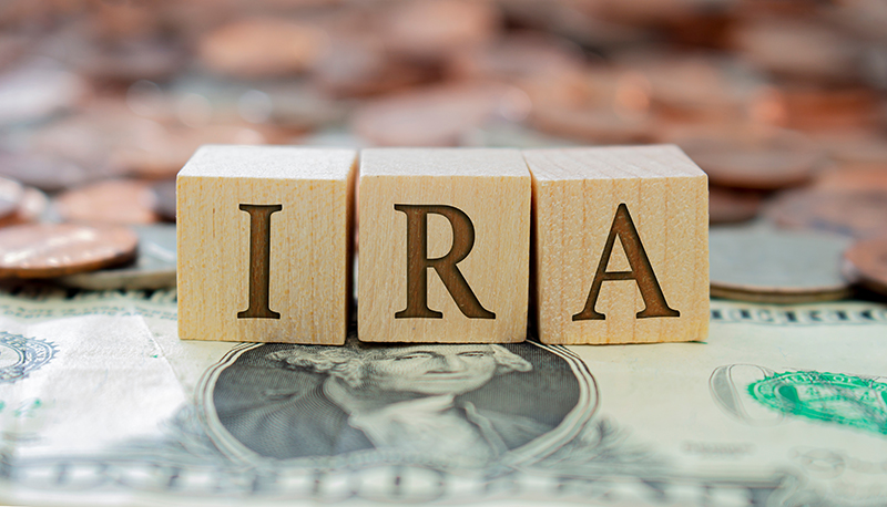 IRA written with blocks on a money background