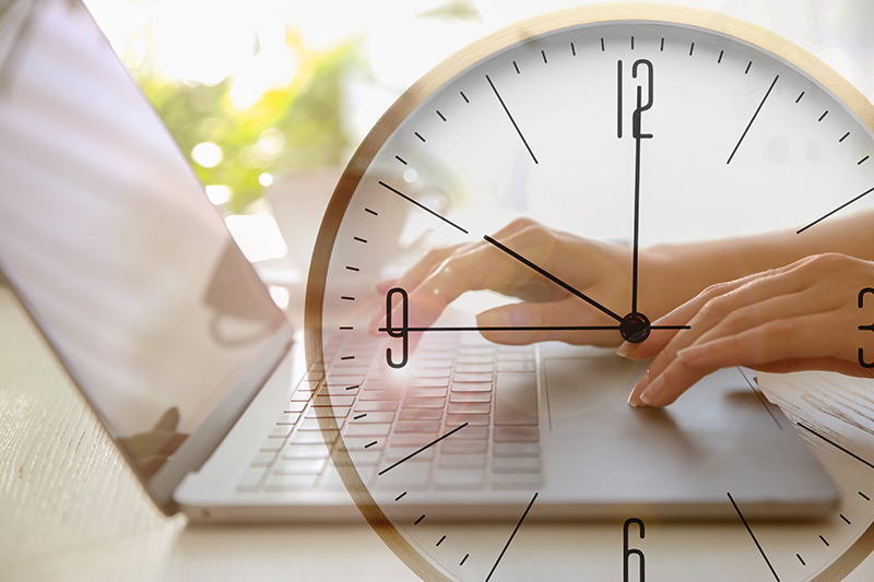 Person working on computer with clock overlay