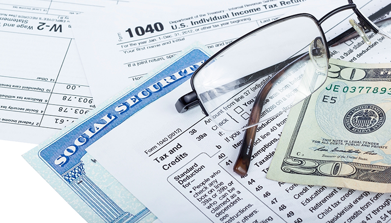 Tax Return, Social Security Card, Glasses, and $20 bill