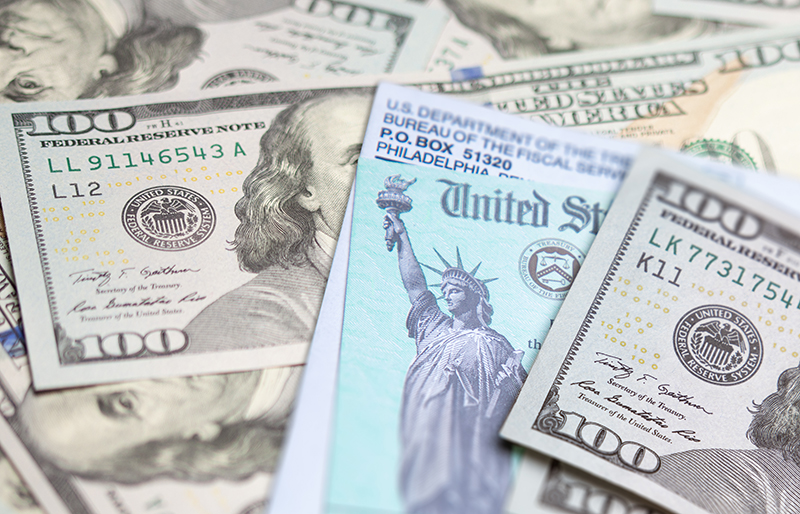 US Treasury Check surrounded by $100 bills